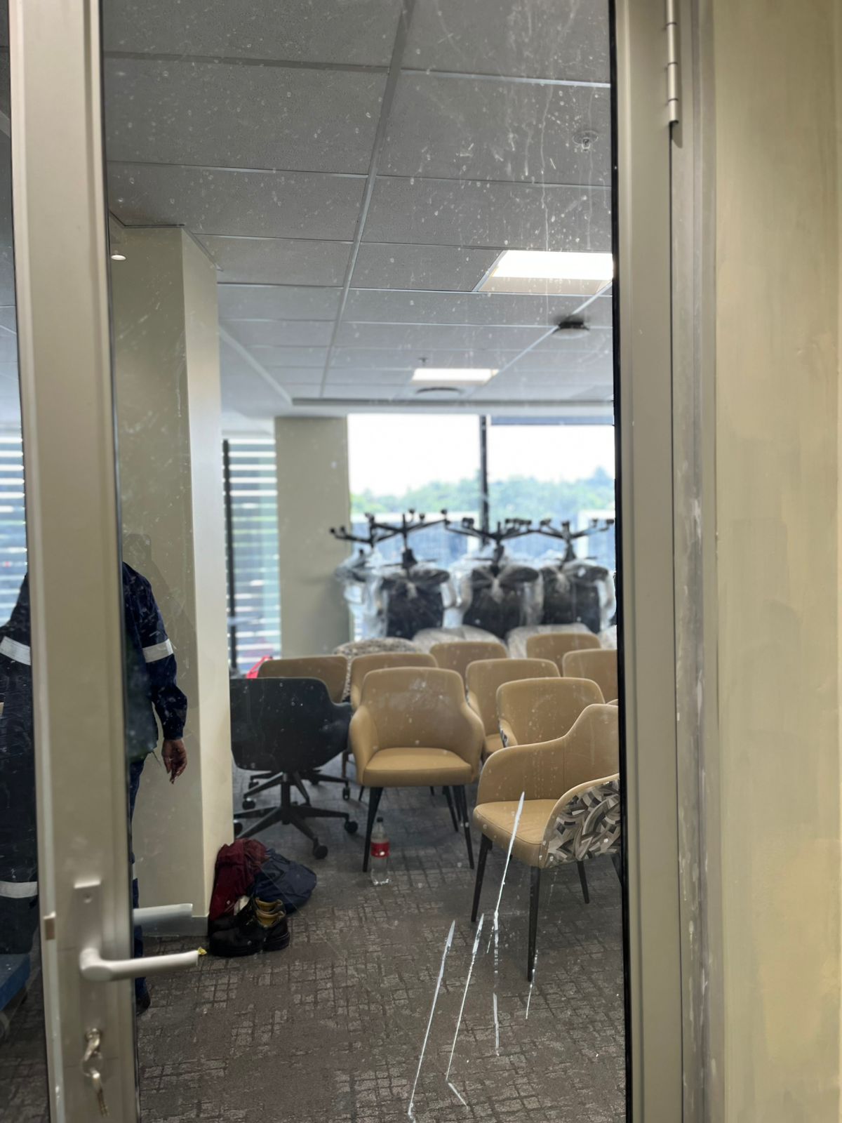 Empty office room viewed through an open glass door